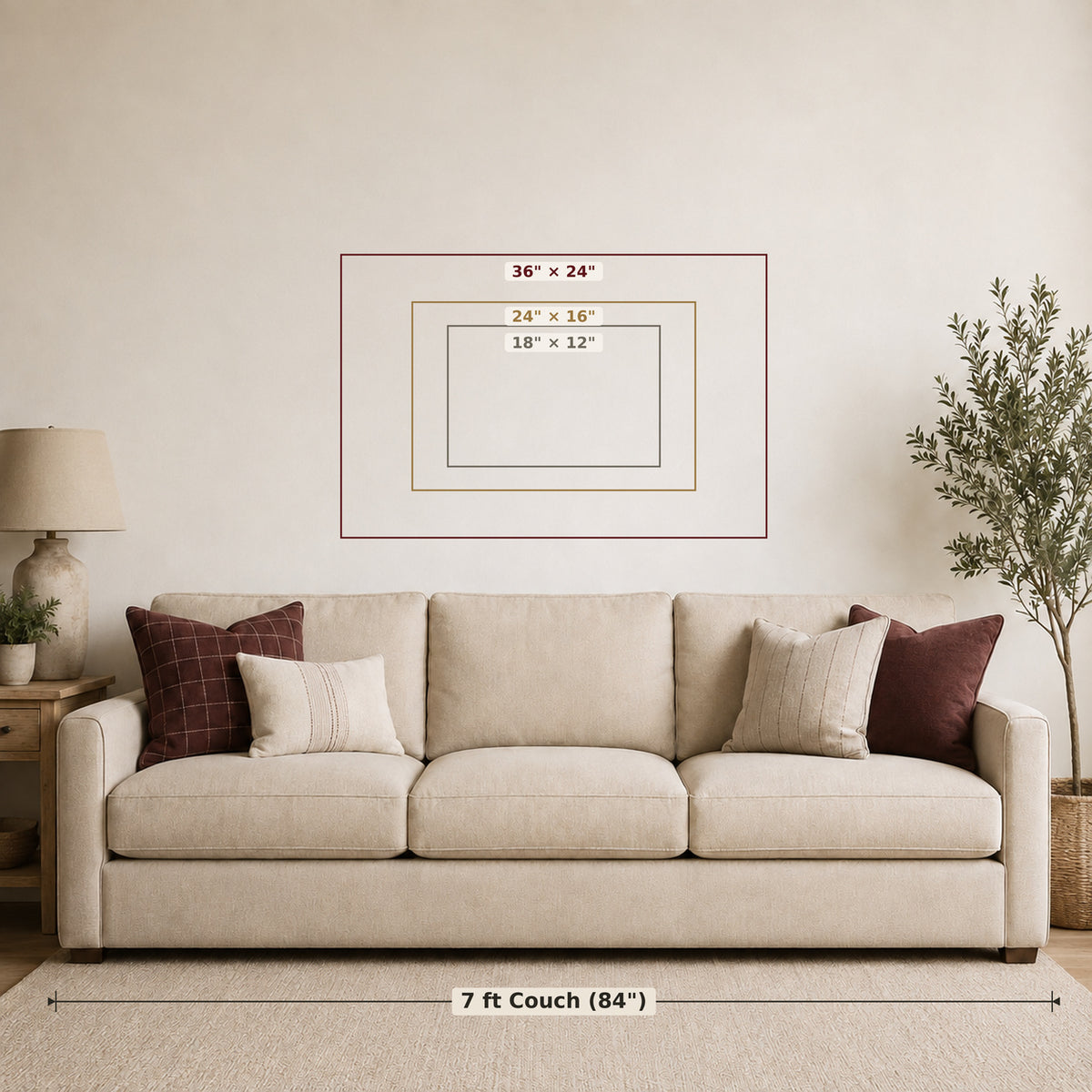 A staged living room scene showing a beige sofa with pillows, a lamp, and a potted plant, with overlaid dimension lines indicating a 7 ft couch (84") and three framed wall art sizes: 36" x 24", 24" x 16", and 18" x 12".