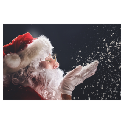 A festive holiday photo print of Santa Claus in profile, wearing his classic red hat with white fur trim and white gloves, blowing snow towards the right against a dark background.